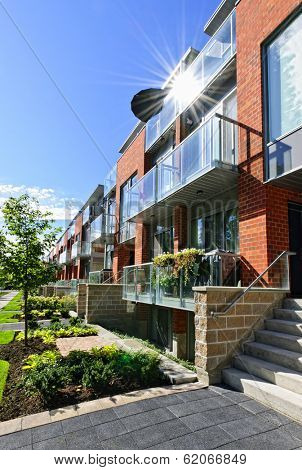 Modern town houses of brick and glass on urban street