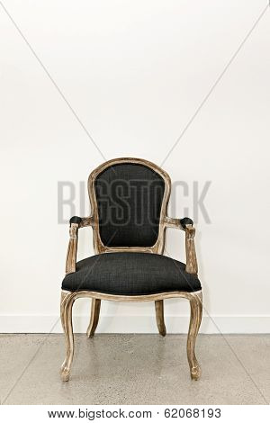 Antique upholstered armchair furniture against white wall