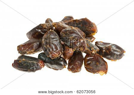 Closeup on pile of dried medjool dates isolated over white background