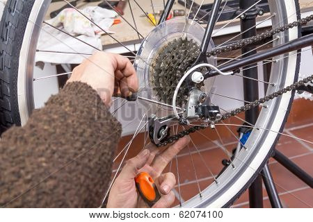 Real bicycle mechanic repairing custom fixie bike