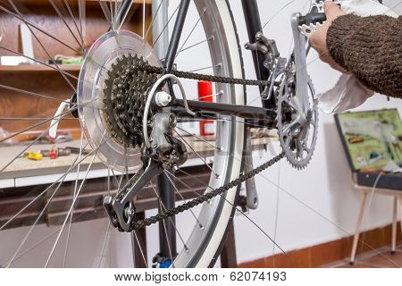 Real bicycle mechanic repairing custom fixie bike