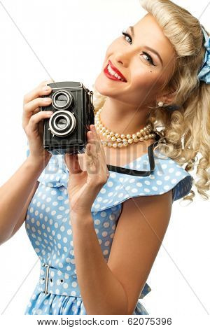 Blond coquette pin up style young woman in blue dress with vintage camera 