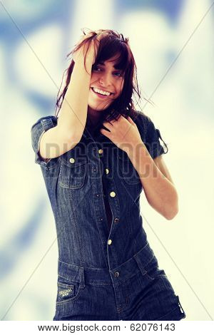 Sexy, beautiful, young woman dancing (hair flying) in jeans siut