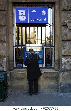 KRAKOW, POLAND, 25 OCTOBER 2003 -- A customer withdraws money from a Bank PKO BP automated teller cash machine. Bank PKO is one of Poland's leading financial institutions.