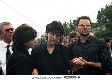 VAKUF, BOSNIA - AUG 17: A woman in comforted by her family after the funeral for her fallen soldier husband in Gornji Vakuf, Bosnia, on Tuesday,  August 17, 1993.