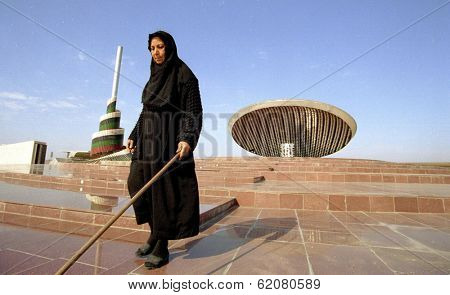 BAGHDAD, IRAQ - MARCH 14: An Iraqi peasant woman cleans the red-marble steps leading to the national tomb of the unknown soldier in Baghdad on March 14, 1999 in Baghdad, Iraq.