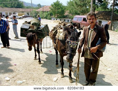 TROPOJE, KOSOVO, 19 JULY 1998 -- A Kosovo Liberation Army (UCK) smuggler brings weapons across the border from neighboring Albania using horses.