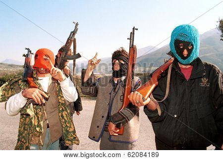 BALSH, ALBANIA, 15 MARCH 1997 -- Albanian militiamen hold a piece of road linking Albania's south with the capital Tirana. Anarchy broke out in Albania after pyramid schemes collapsed last month