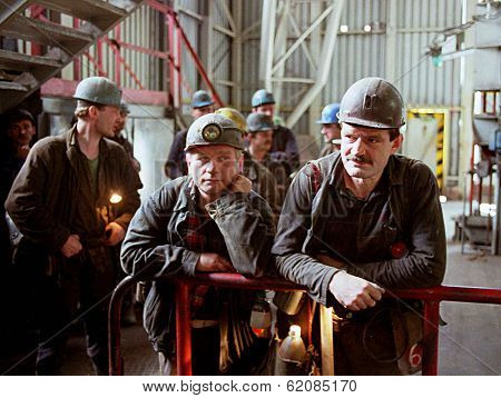KATOWICE - MAY 16:  Coal miners from the Katowice  II (KWK) coal mine await the elevator that will take them 1800 feet below the earth in Katowice, Poland, on May 16, 2001.