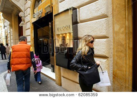 ROME - MARCH 13:  Luxury shopping along Via Condotti in Rome, Italy, on March 13, 2005. Shoppers pass a Gucci shop.