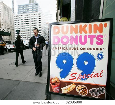 NEW YORK CITY - APRIL 19: A man walks out from a Dunkin' Donuts franchise in New York City, on Friday, April 19, 2013.