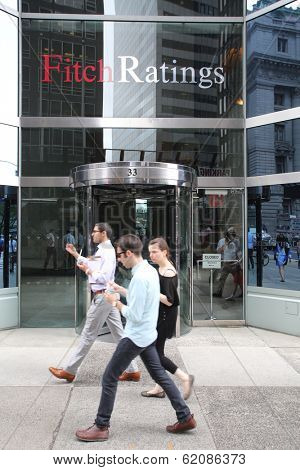 NEW YORK CITY - JULY 11: Pedestrians walk past the headquarters of Fitch Ratings in lower Manhattan on Thursday, July 11, 2013. Fitch Group is a jointly owned by Hearst Corporation and FIMALAC SA