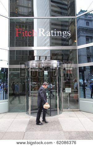 NEW YORK CITY - JULY 11: Pedestrians walk past the headquarters of Fitch Ratings in lower Manhattan on Thursday, July 11, 2013. Fitch Group is a jointly owned by Hearst Corporation and FIMALAC SA