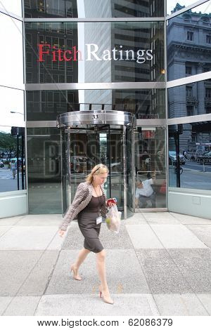 NEW YORK CITY - JULY 11: Pedestrians walk past the headquarters of Fitch Ratings in lower Manhattan on Thursday, July 11, 2013. Fitch Group is a jointly owned by Hearst Corporation and FIMALAC SA