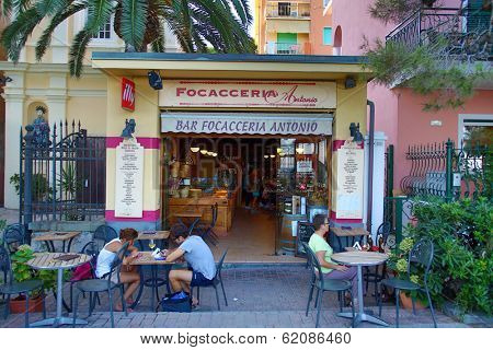 MONTEROSSO - ITALY: AUG 17: People sit outdoors eating focaccia bread along the coast of Cinque Terre in Monterosso, Italy, on Sunday, August 17, 2013. 