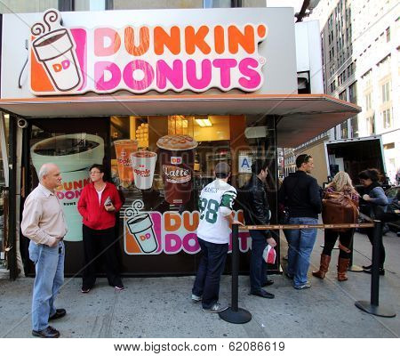 NEW YORK CITY - OCT 20 2013: People line up for coffee and donuts at a Dunkin' Donuts store in Manhattan on Sunday, October 20, 2013. 