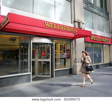NEW YORK CITY - OCT 24 2013:  Pedestrians walk past a branch office of Wells Fargo & Company bank in Manhattan on Sunday, October 20, 2013. 