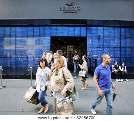 NEW YORK CITY - OCT 18:  Pedestrians walk past a a Hollister clothing store in Manattan on Friday, October 18, 2013. Hollister Co.,  is an American lifestyle brand by Abercrombie & Fitch Co 