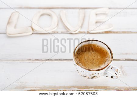 LOVE sign letters with espresso coffee in white cup,  old rustic  style table, shallow dof