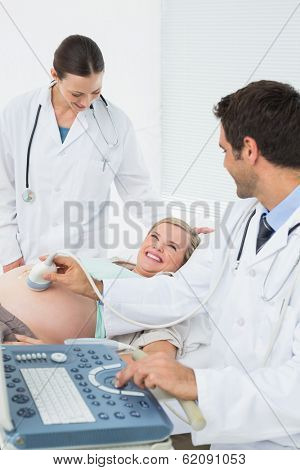Excited pregnant woman having a sonogram scan at the hospital