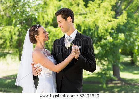 Young bride and groom couple dancing on wedding day