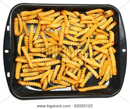 Homemade Oven Baked Crinkle Fries in Broiler Pan over White.