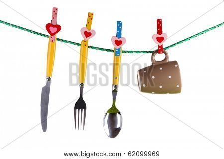 Crockery dried on rope isolated on white