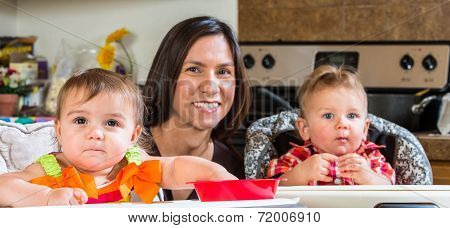 Mother Smiles With Babies