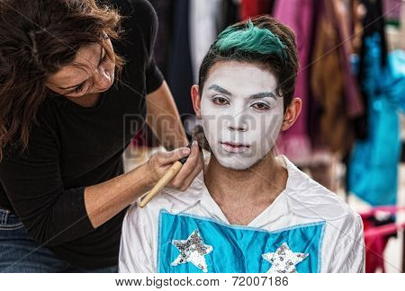 Woman Brushing Makeup On Clown