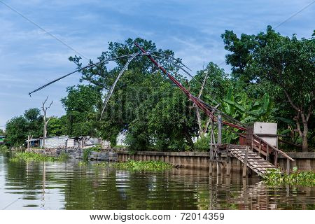 Old Fishnet In Thai Style House Next To River
