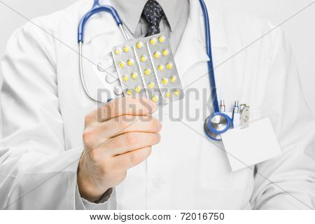 Doctor Holdling Pills In His Hand