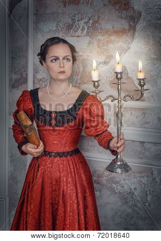 Beautiful Woman In Medieval Dress With Candelabrum