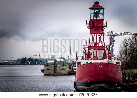 light house on a red ship in the harbor