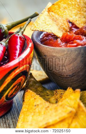 Salsa with tortilla chips and chilli peppers.Concept