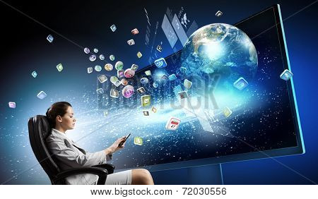 Young businesswoman in chair near tv screen with click. Elements of this image are furnished by NASA