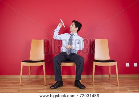 Businessman trowing paper planes