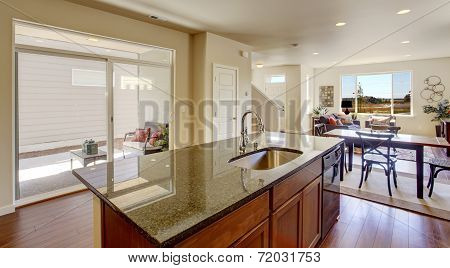 House Interior With Open Floor Plan. Kitchen Island With Granite Top