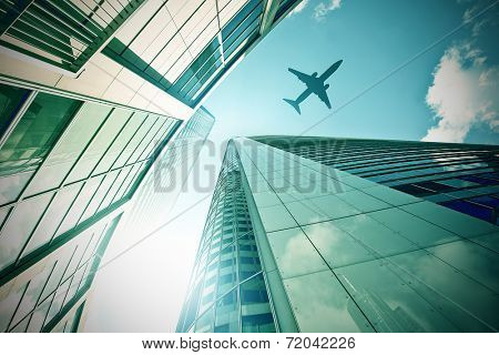 plane flying over a modern glass and steeel office towers in Frankfurt am Main, Germany