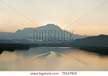 Fisheman Headding Home At Early Morning With Mountain As Background