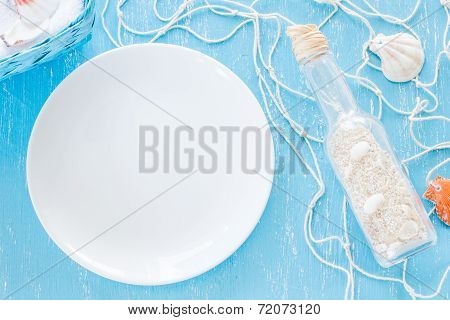 Glass Bottle With Sand And Empty White Plate