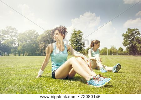 Two Young Girls Stetching Before A Jogging
