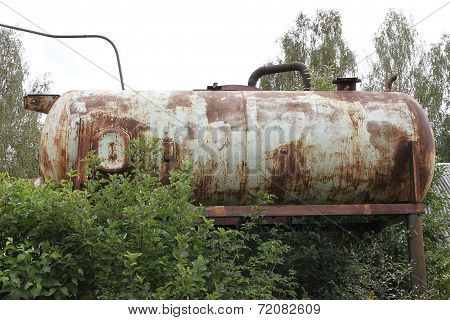 An old rusty cistern of a pressure water station at the dacha in Russia