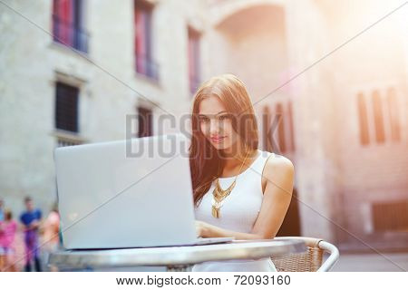 Attractive woman typing something on a laptop keyboard