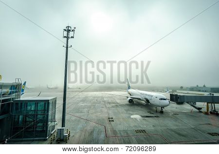 The Plane At The Airport In The Fog