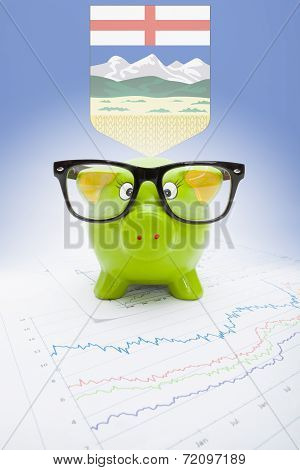 Piggy Bank With Canadian Province Flag On Background - Alberta