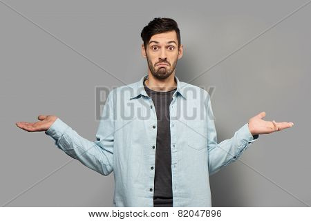 Young man spreading his hands
