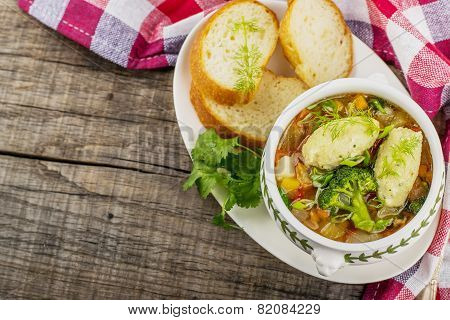 Soup with dumplings in a white plate