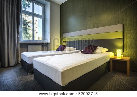 Two Single Beds In Green Hotel Room