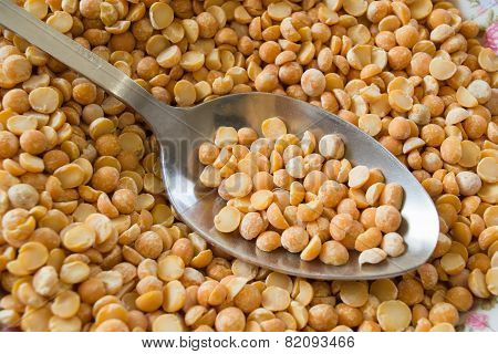 Background Yellow Peas With An Iron Spoon