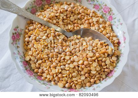 Yellow Peas On The Plate With An Iron Spoon